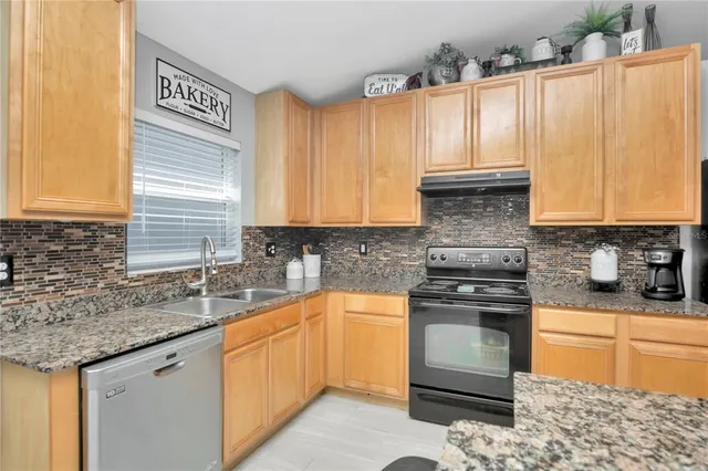 a kitchen with a sink stove and cabinets
