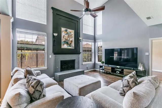a living room with furniture a fireplace and a flat screen tv