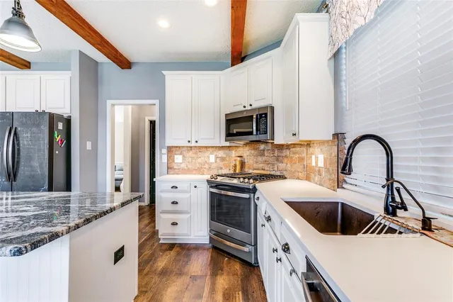 a kitchen that has a sink and a stove