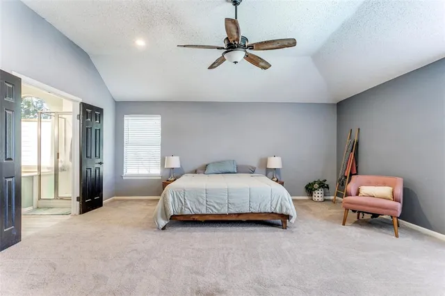 a spacious bedroom with a bed and a window