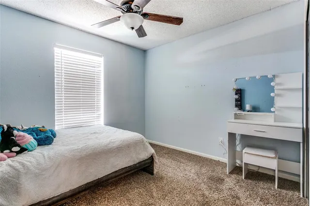 a bedroom with a bed and a desk