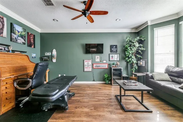 a living room with furniture a window and a flat screen tv