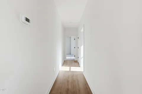 a view of a hallway with entryway and stairs