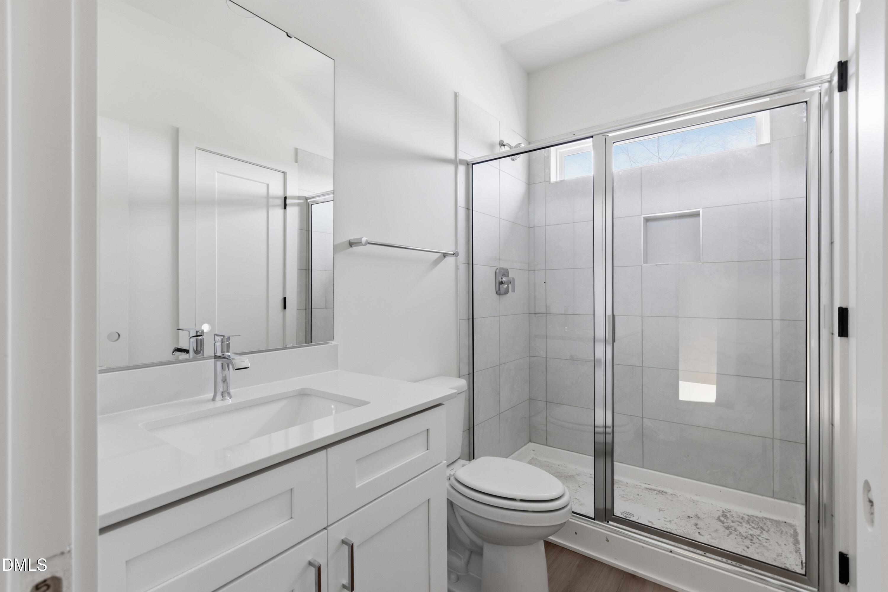 3814 Granite Mill Way Raleigh, NC 27616 - Photo 16 of 48 a bathroom with a shower sink vanity and toilet