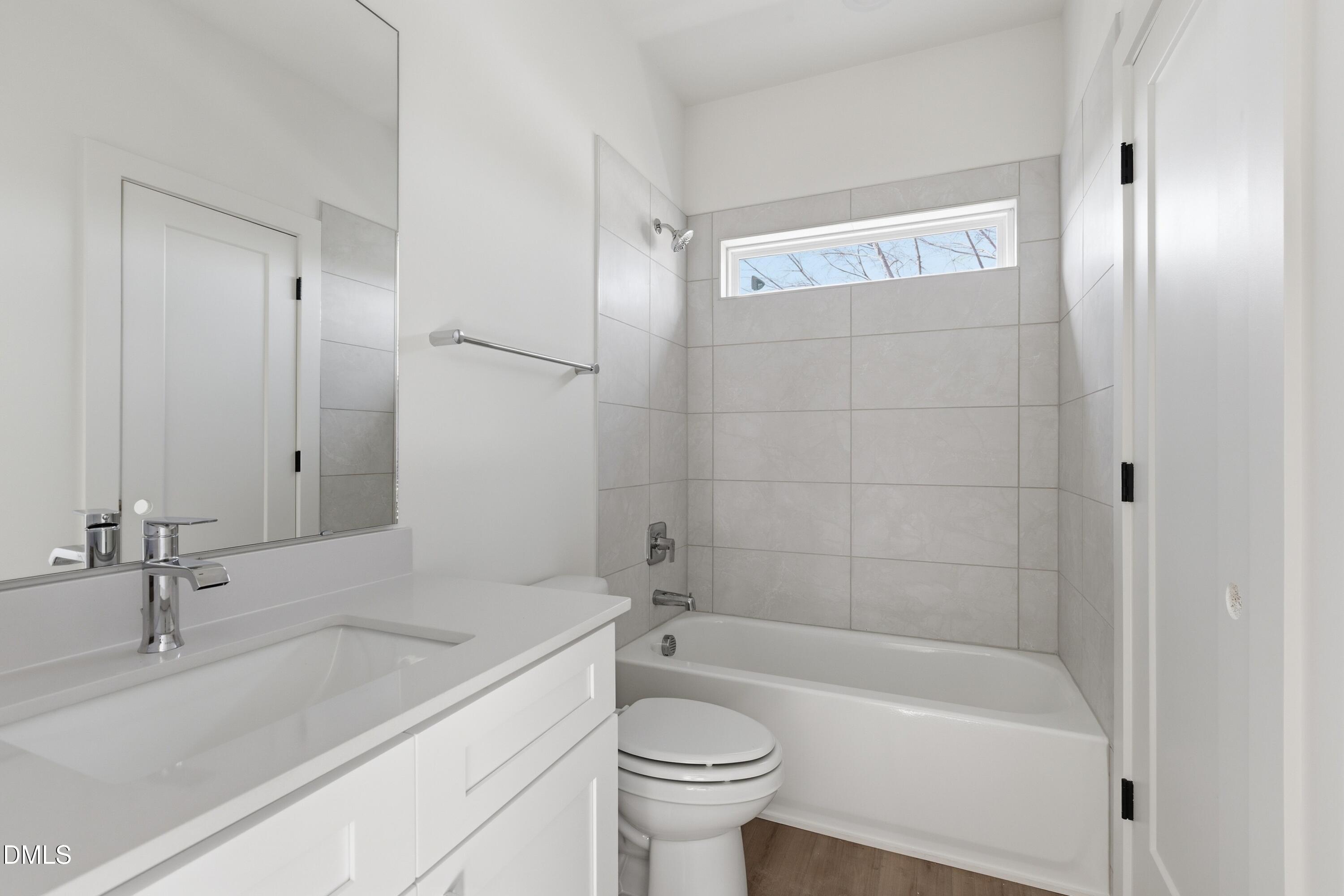 3814 Granite Mill Way Raleigh, NC 27616 - Photo 18 of 48 a bathroom with a sink a toilet and shower