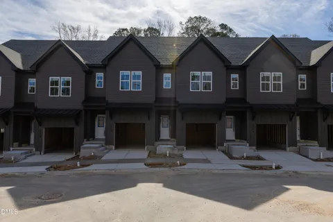 a kitchen with stainless steel appliances kitchen island granite countertop a dining table chairs and sink