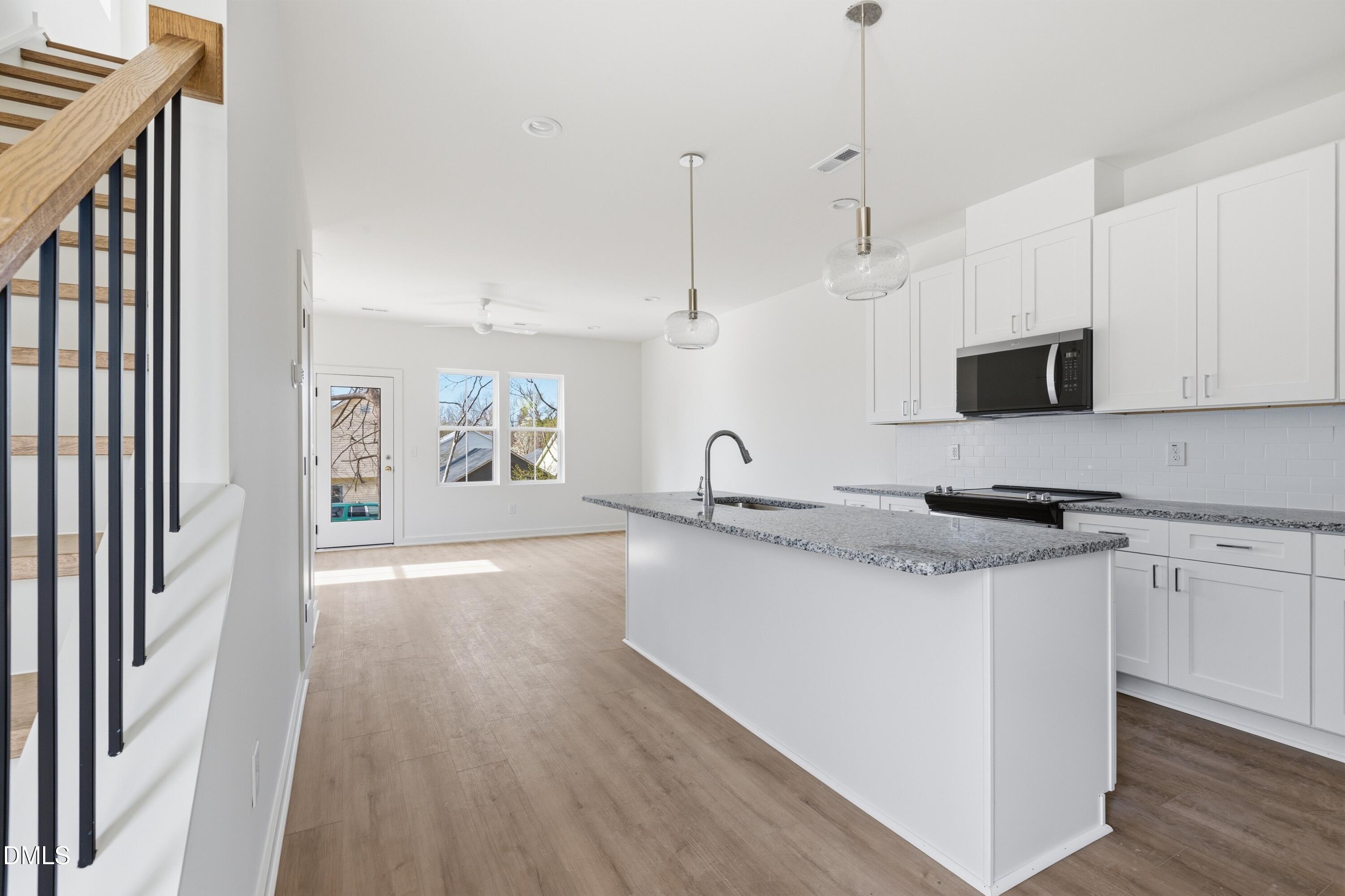 3814 Granite Mill Way Raleigh, NC 27616 - Photo 2 of 48 a kitchen with stainless steel appliances granite countertop a sink dishwasher a stove and a refrigerator with wooden floor