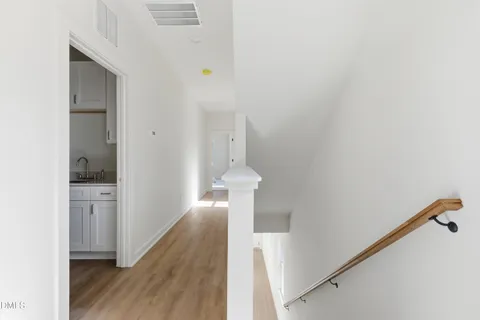 a view of entryway and hall with wooden floor