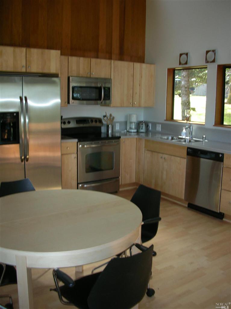 a kitchen with kitchen island a sink appliances and cabinets