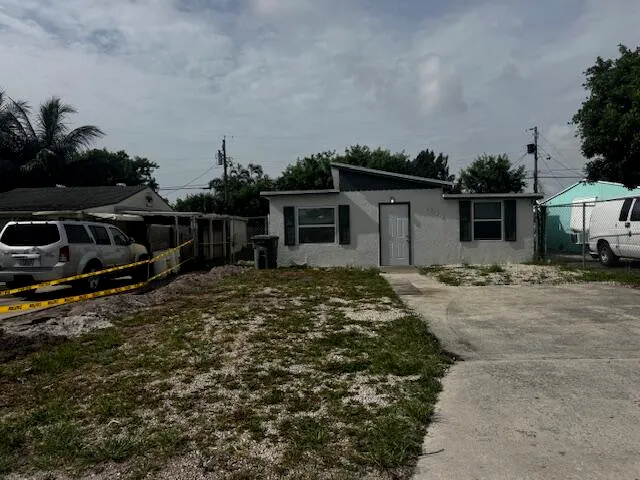a backyard of a house with lots of green space and wooden fence