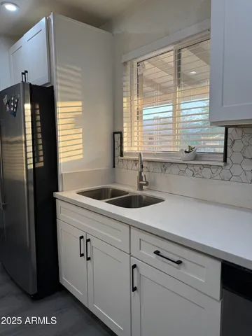 a kitchen with a sink and refrigerator