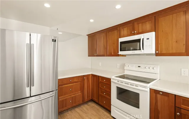 a kitchen with a stove microwave and refrigerator