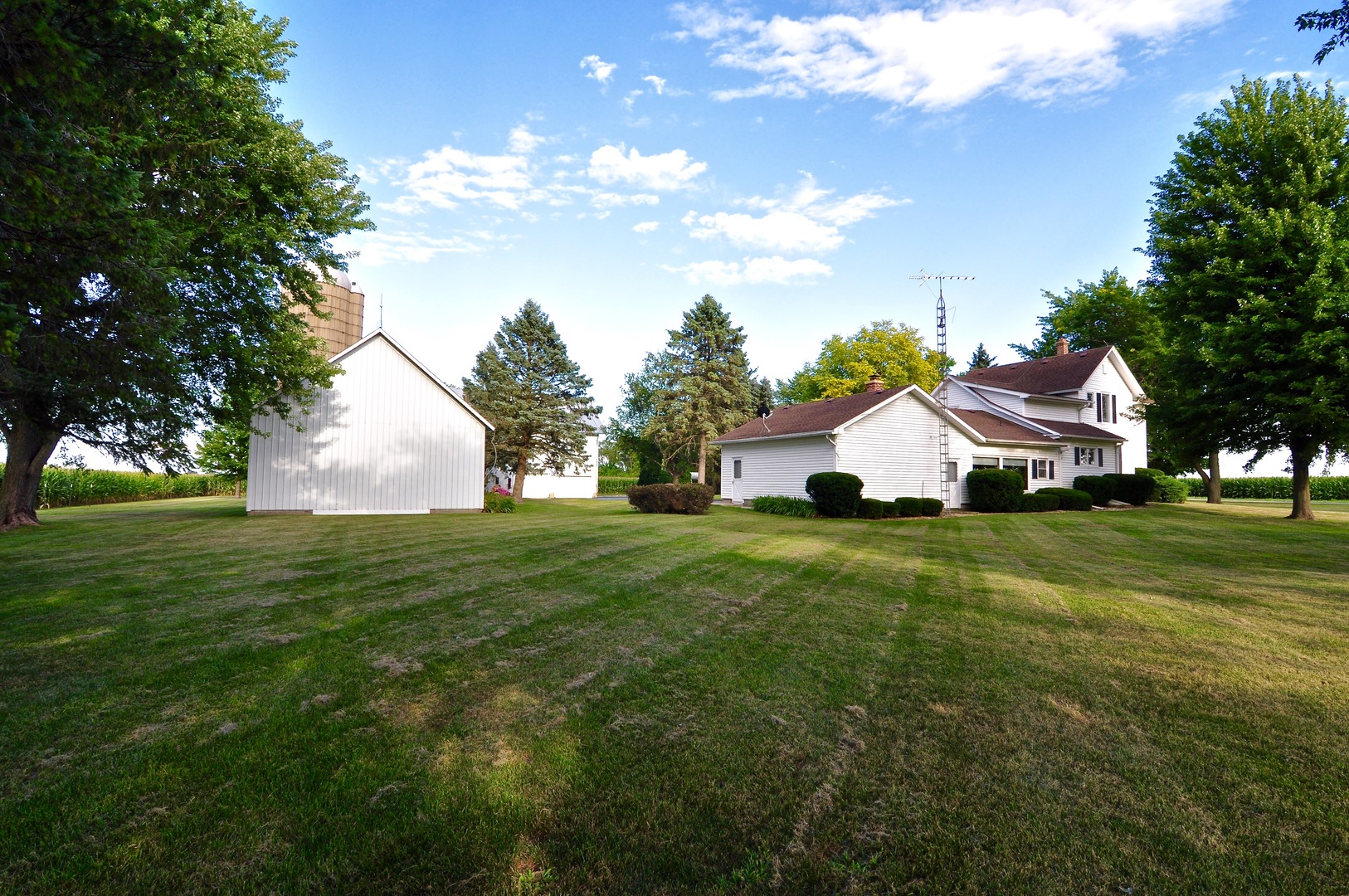 16053 Owens Road Hinckley, IL 60520 - Photo 14 of 68 a front view of a house with garden