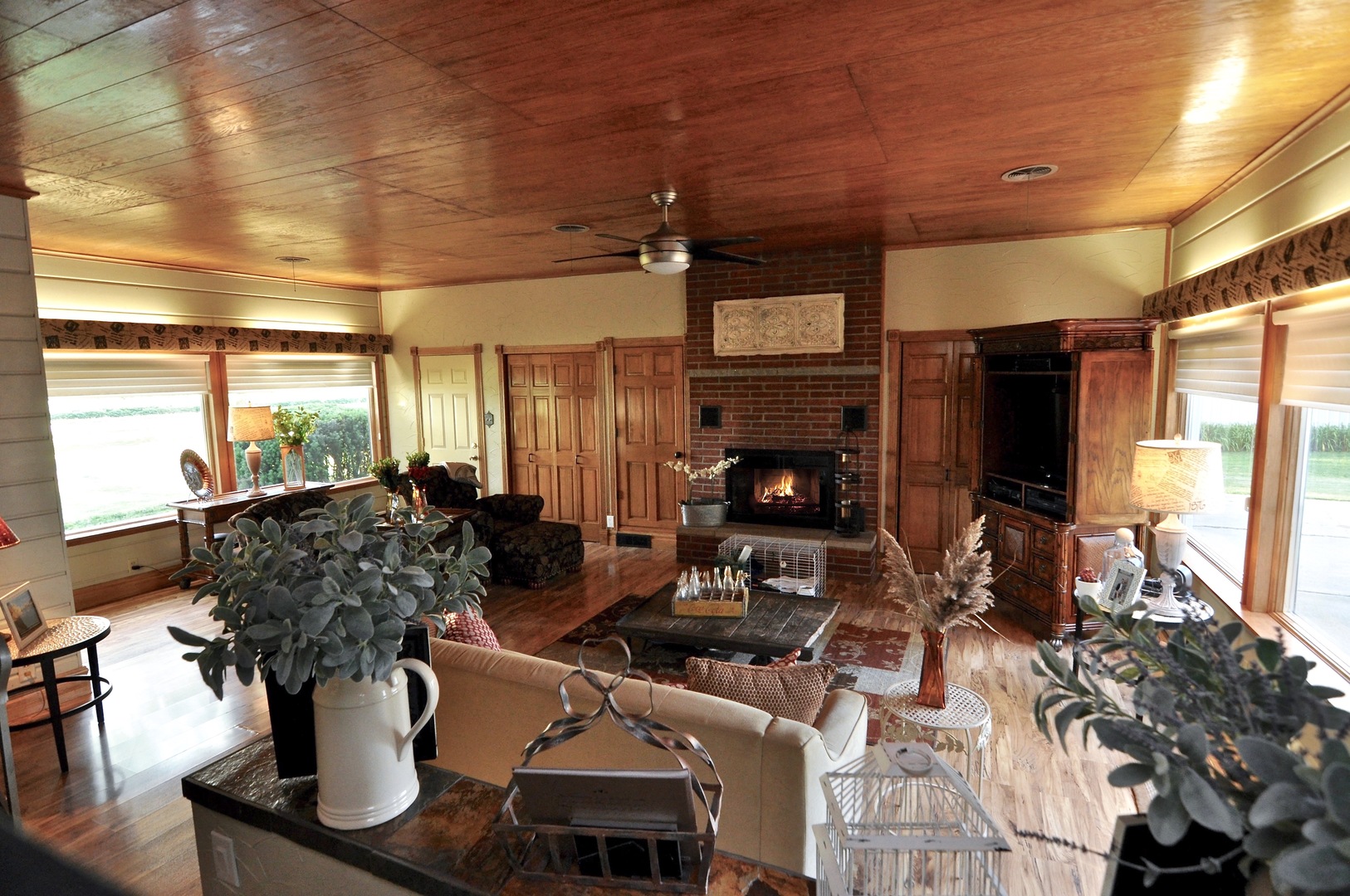 16053 Owens Road Hinckley, IL 60520 - Photo 26 of 68 a living room with furniture a flat screen tv and a fireplace