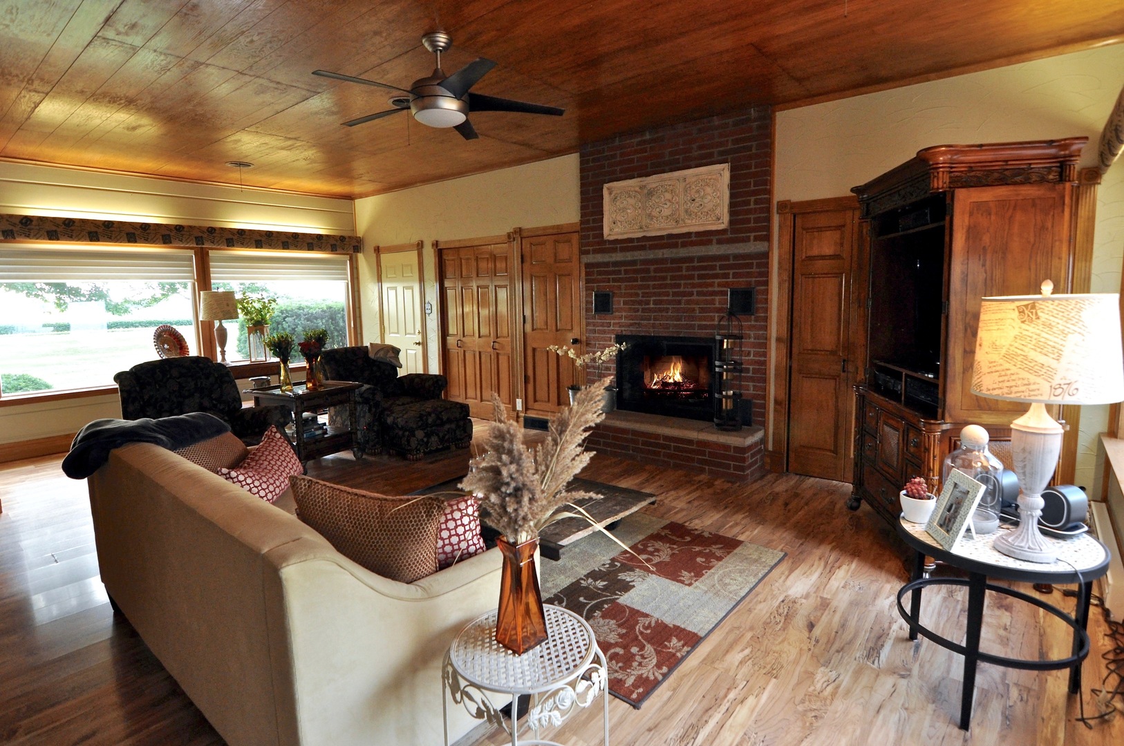 16053 Owens Road Hinckley, IL 60520 - Photo 29 of 68 a living room with furniture a fireplace and a dining table with wooden floor