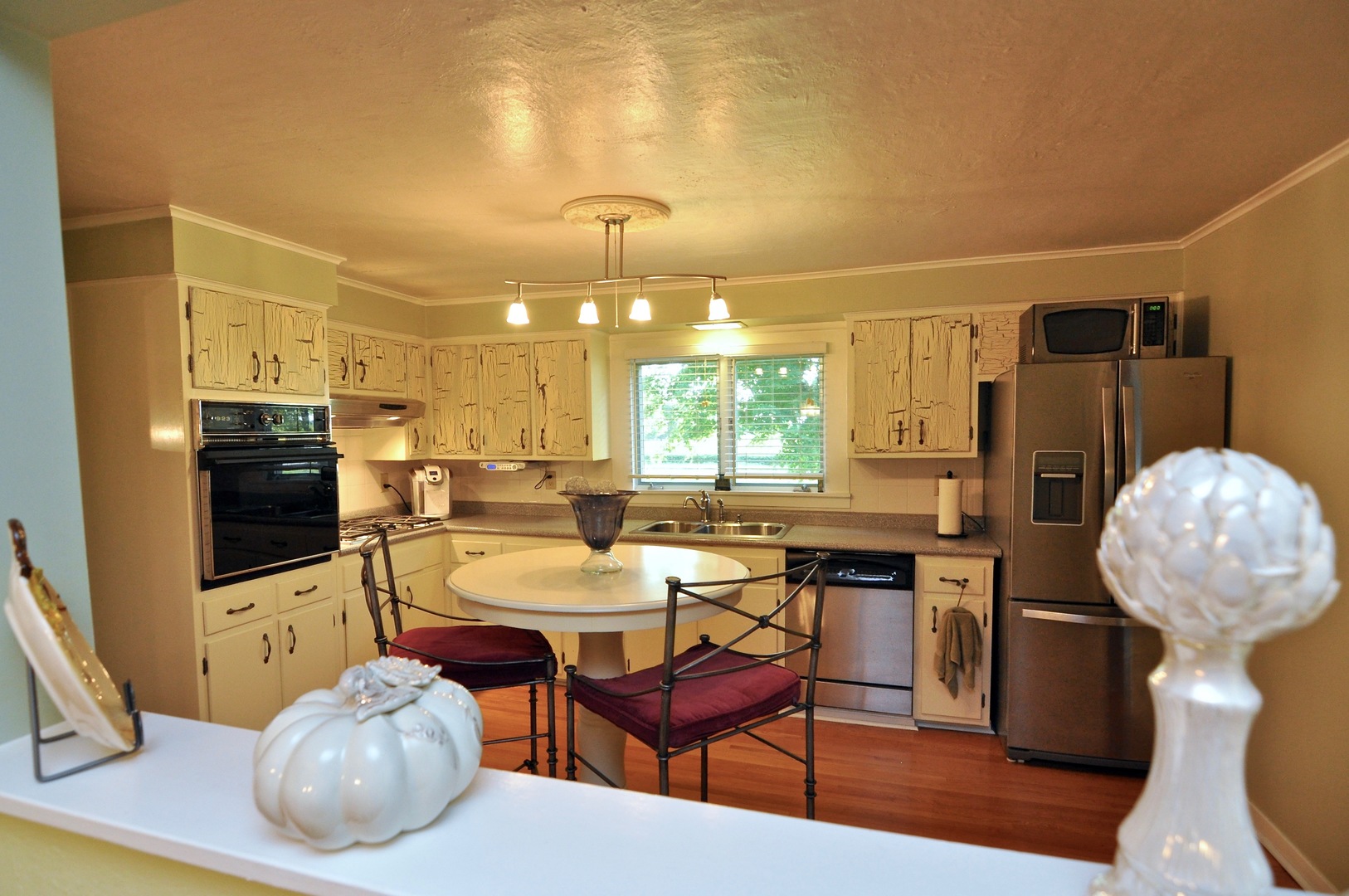 16053 Owens Road Hinckley, IL 60520 - Photo 43 of 68 a kitchen with stainless steel appliances a dining table chairs and granite counter tops