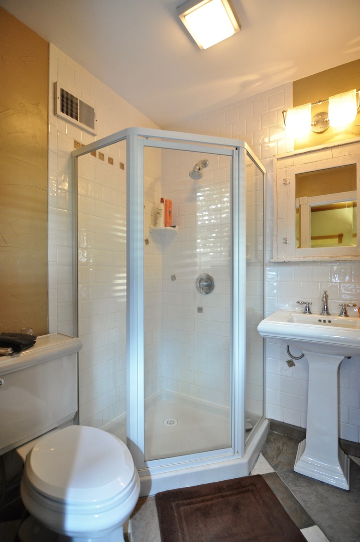 16053 Owens Road Hinckley, IL 60520 - Photo 49 of 68 a bathroom with a toilet a sink and shower