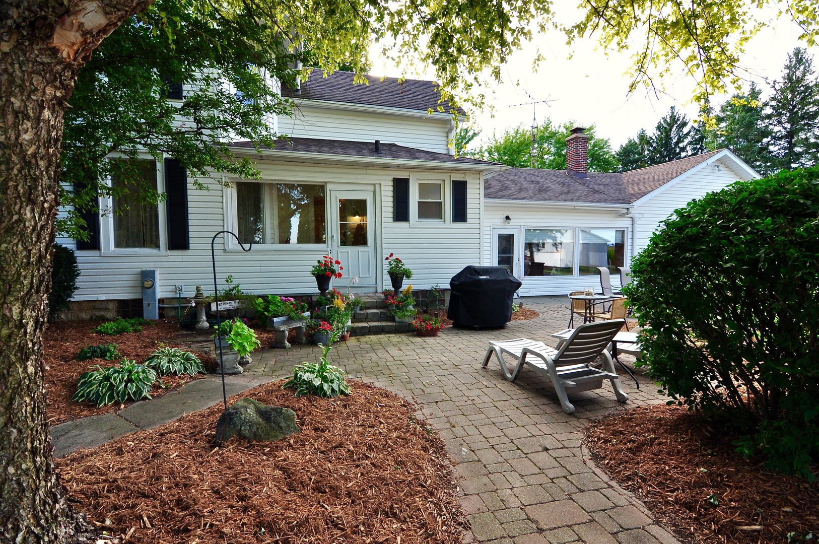 16053 Owens Road Hinckley, IL 60520 - Photo 7 of 68 a view of a house with backyard sitting area and garden