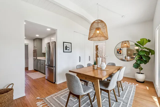 a dining room with furniture and wooden floor