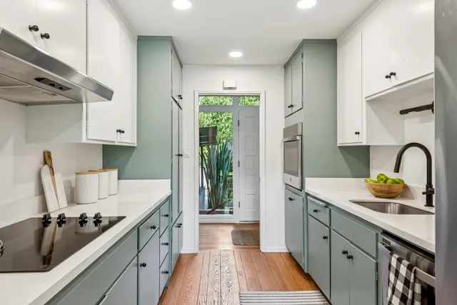 a kitchen with a sink stove and refrigerator