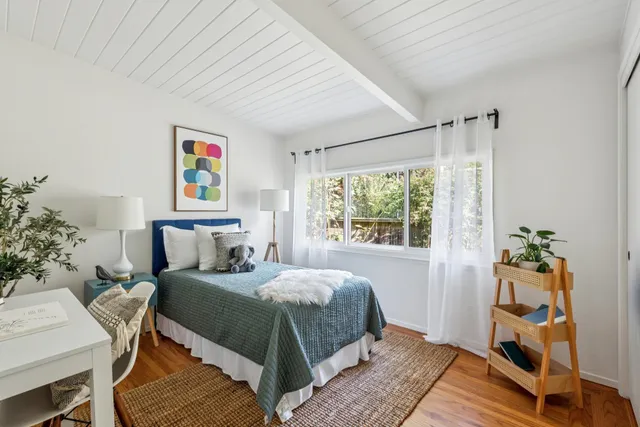 a bedroom with a bed and a table in it