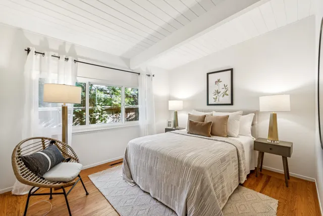 a bedroom with a bed and a window