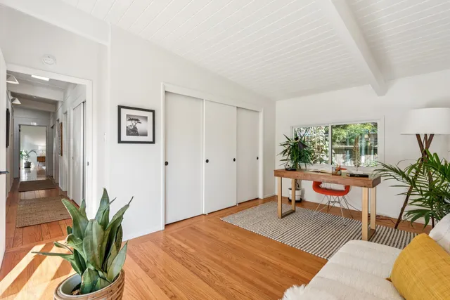 a bedroom with a bed and a potted plant