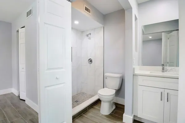a bathroom with a toilet sink and shower