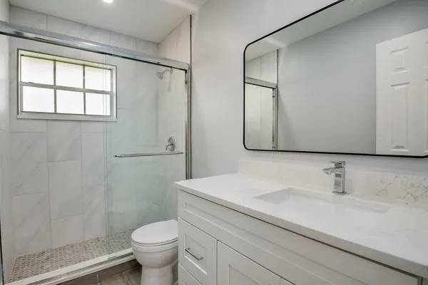 a bathroom with a sink toilet and shower