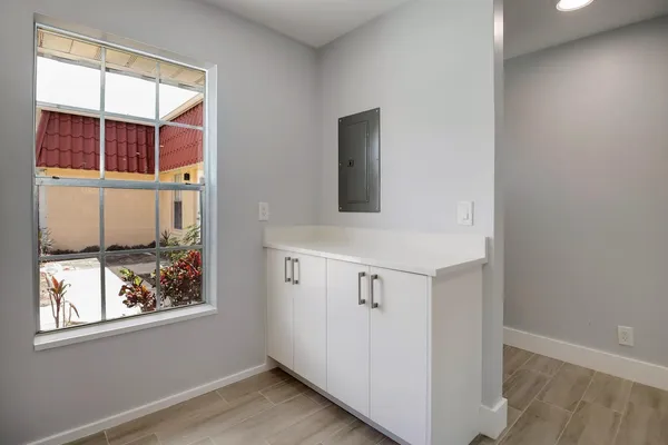 an entryway with wooden floor and cabinet