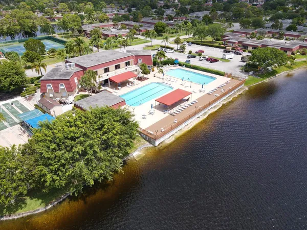 an aerial view of residential houses with outdoor space and trees