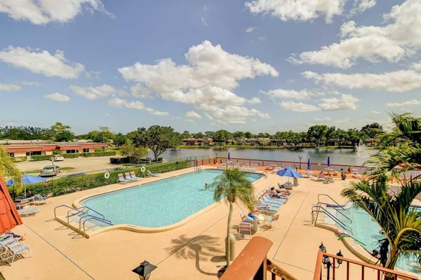 a view of a swimming pool and an outdoor seating