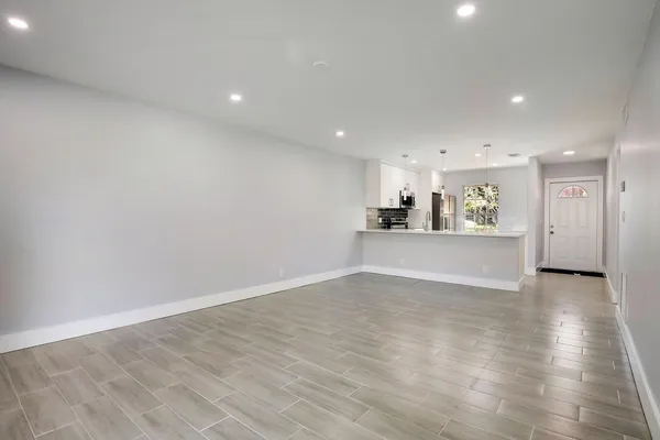 a view of a kitchen with a sink and a refrigerator