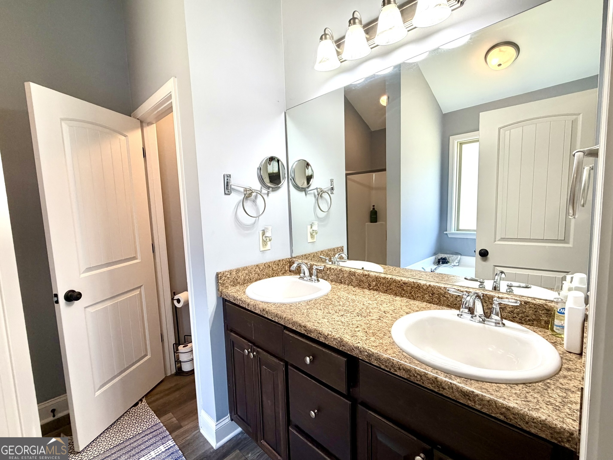 111 Bridle Path Griffin, GA 30224 - Photo 14 of 20 a bathroom with a granite countertop sink and a mirror