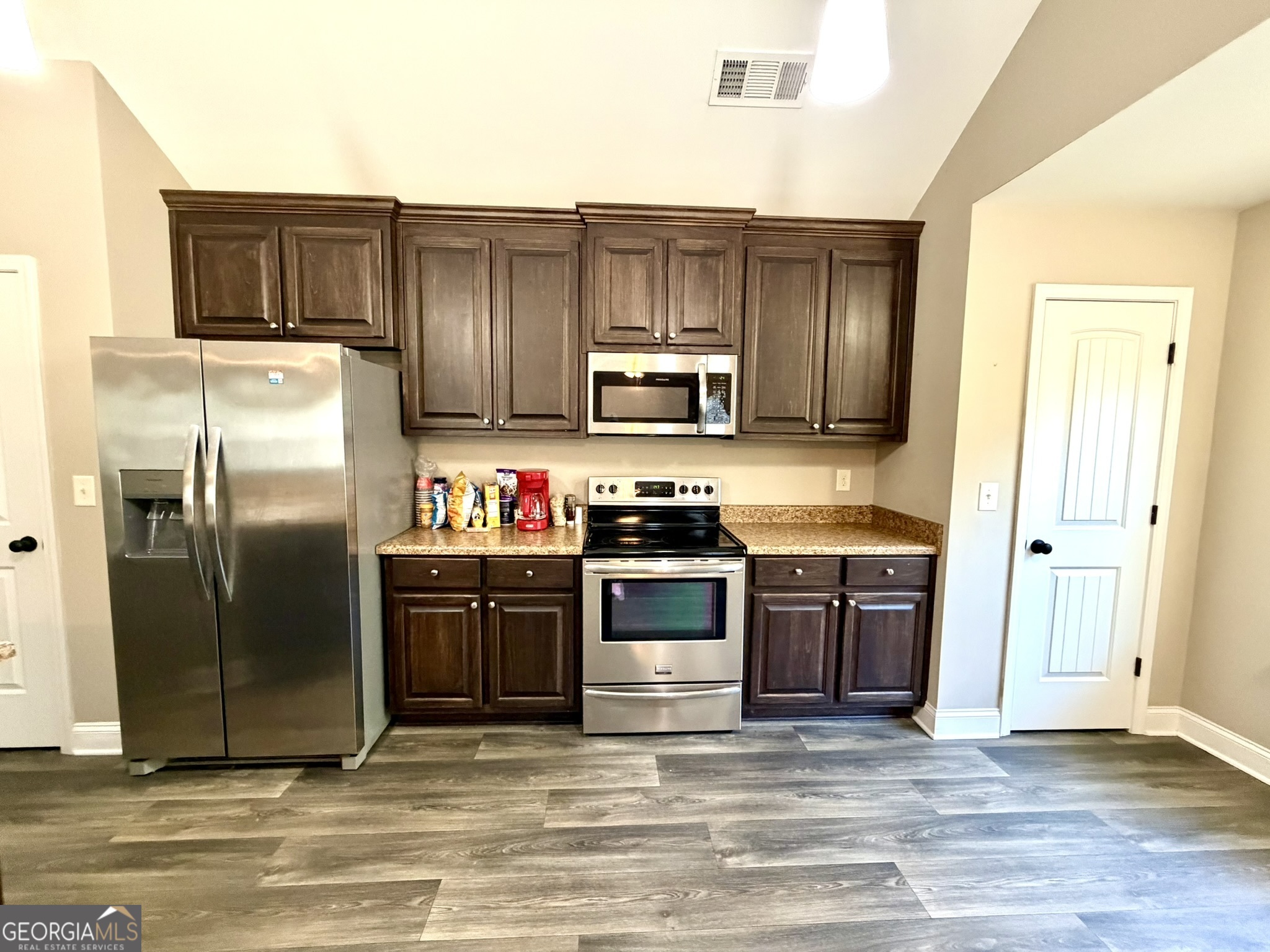 111 Bridle Path Griffin, GA 30224 - Photo 6 of 20 a kitchen with stainless steel appliances granite countertop a refrigerator stove and sink