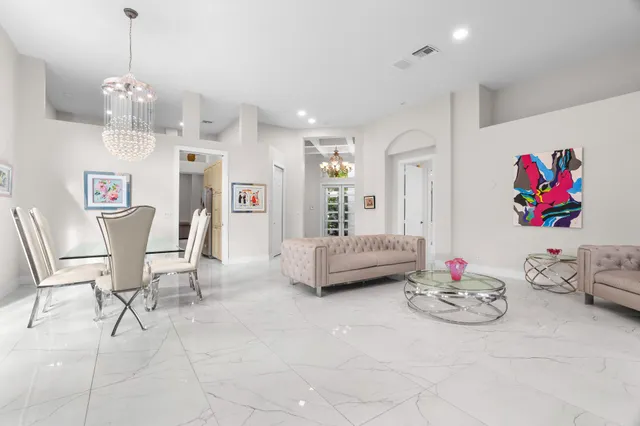 a living room with furniture and kitchen view