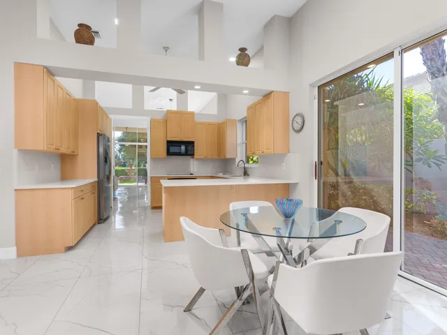 a kitchen with stainless steel appliances granite countertop a sink a refrigerator and a stove