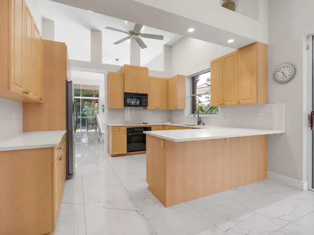 a kitchen with stainless steel appliances a sink stove and cabinets
