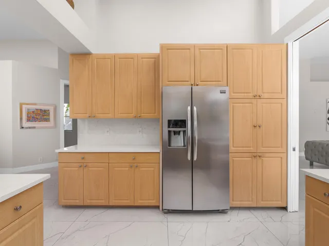 a kitchen with stainless steel appliances granite countertop a refrigerator and a stove