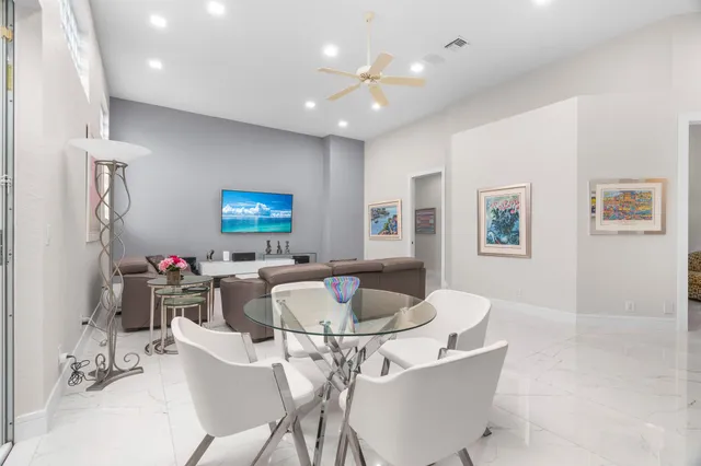 a view of a dining room with furniture and a chandelier