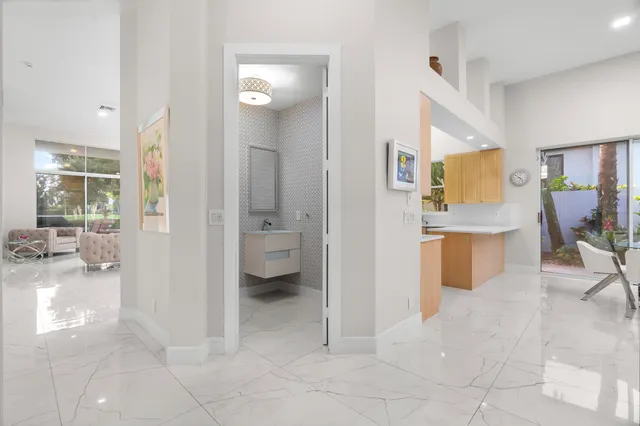 a view of a hallway with living room and dining room view