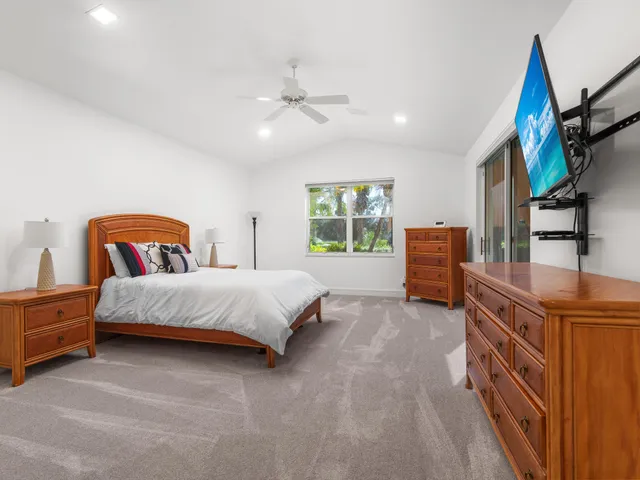 a bedroom with a bed next to a window with outer view