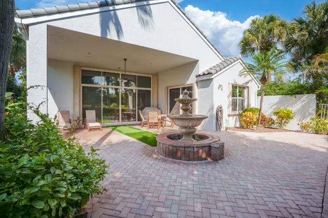 a view of a patio with couches and a potted plant