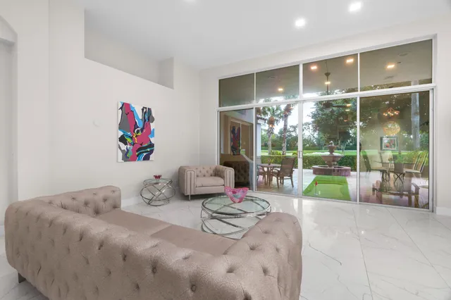 a bedroom with furniture and large windows