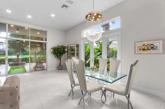 a view of a dining room with furniture a chandelier and wooden floor