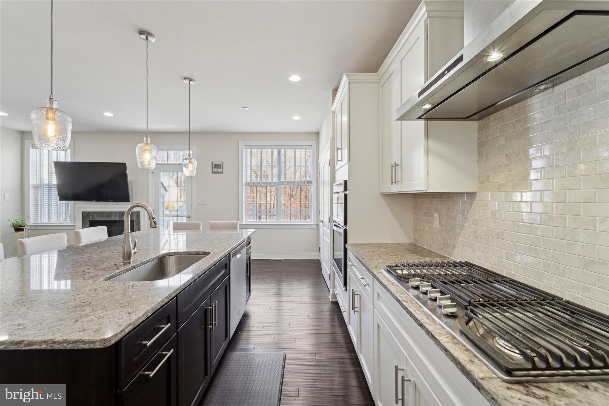 311 Corvus Circle Springfield, PA 19064 - Photo 16 of 51 a kitchen with granite countertop a sink stove and cabinets