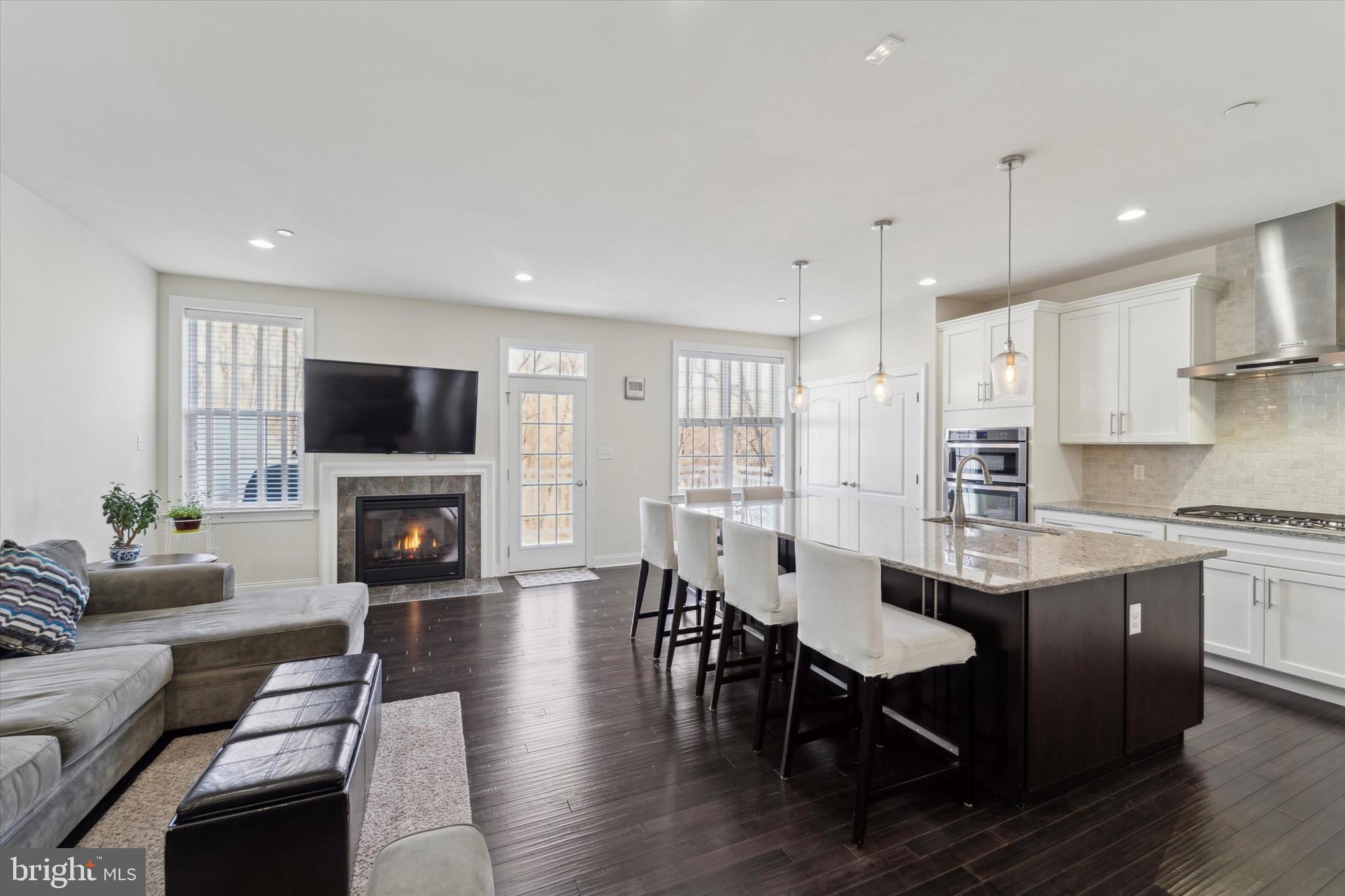 311 Corvus Circle Springfield, PA 19064 - Photo 9 of 51 a open kitchen with granite countertop a stove a sink a dining table and chairs