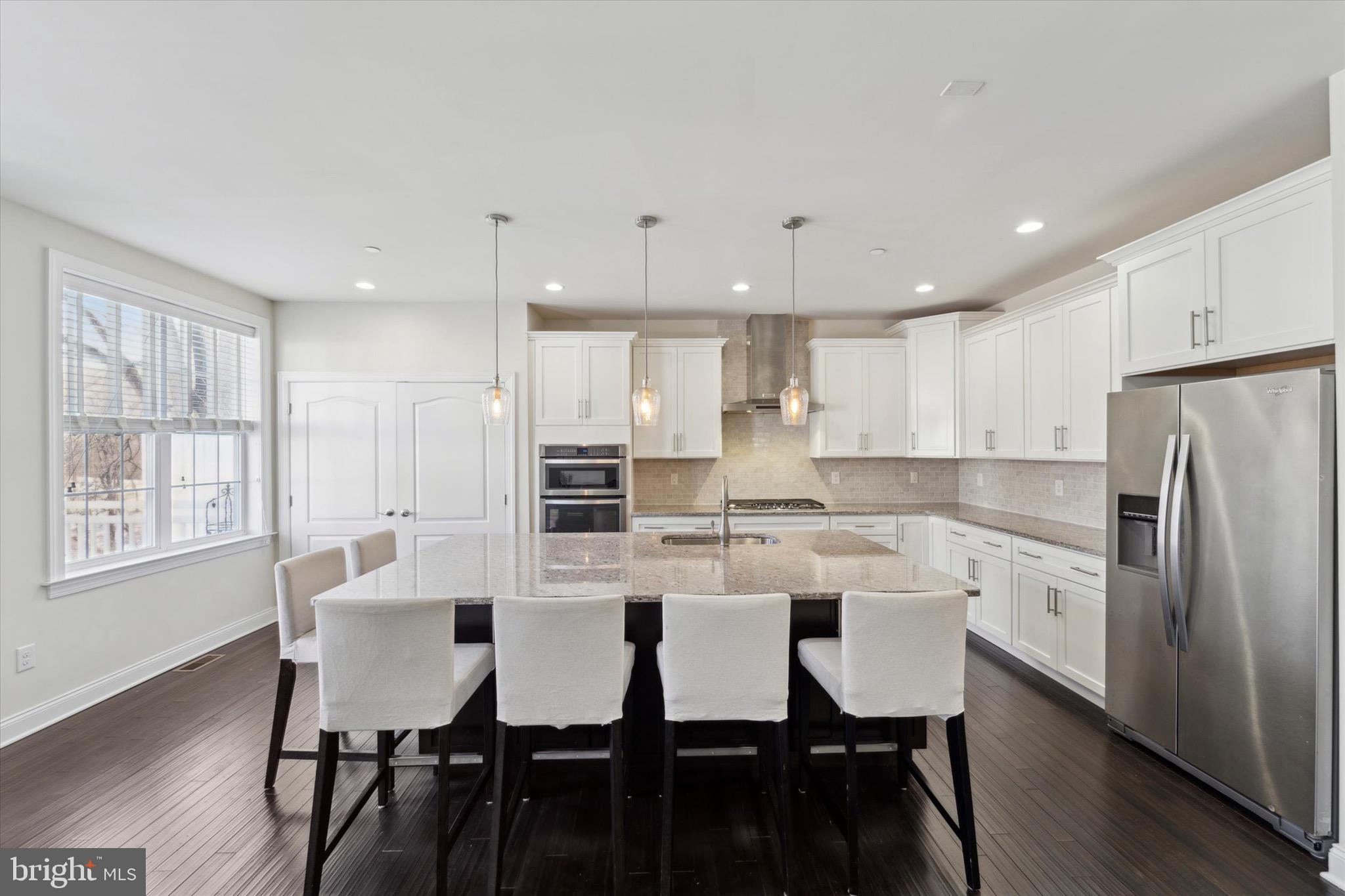 311 Corvus Circle Springfield, PA 19064 - Photo 10 of 51 a kitchen with stainless steel appliances granite countertop a dining table chairs refrigerator and sink
