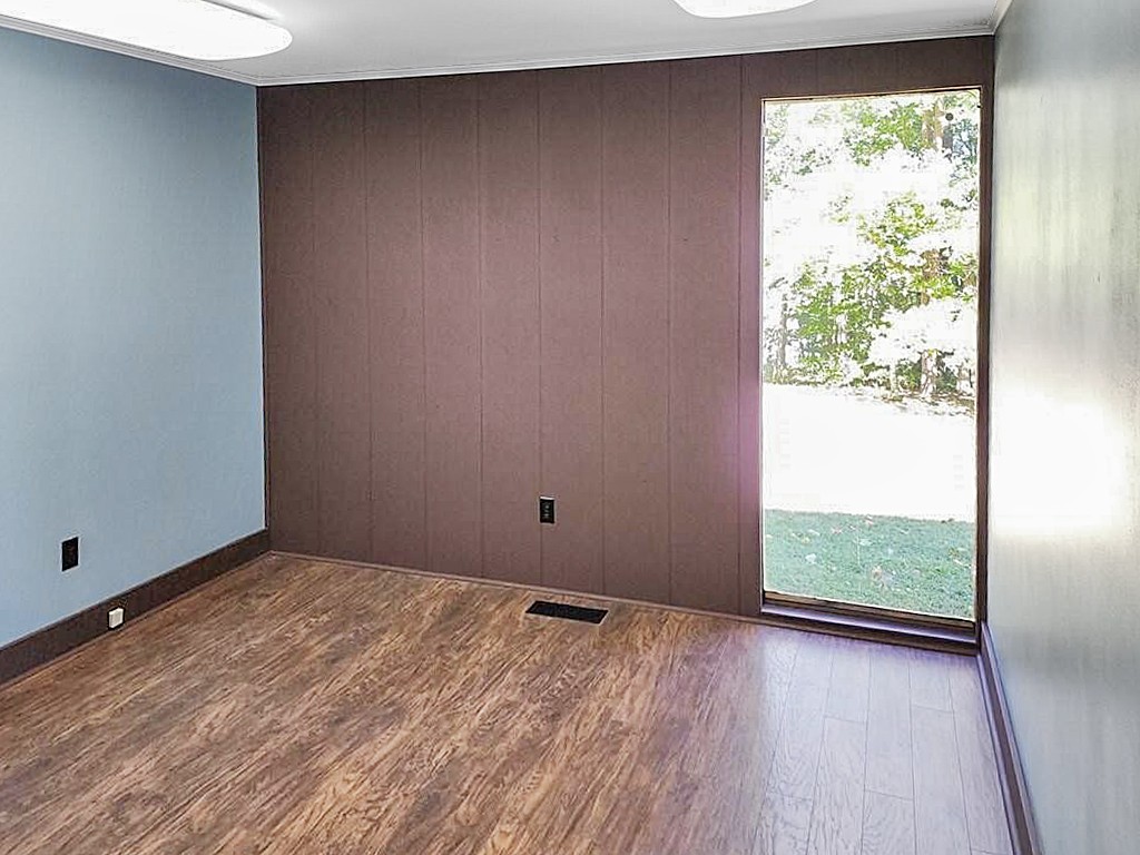 395 River Road Decatur, TN 37322 - Photo 7 of 11 an empty room with wooden floor and windows