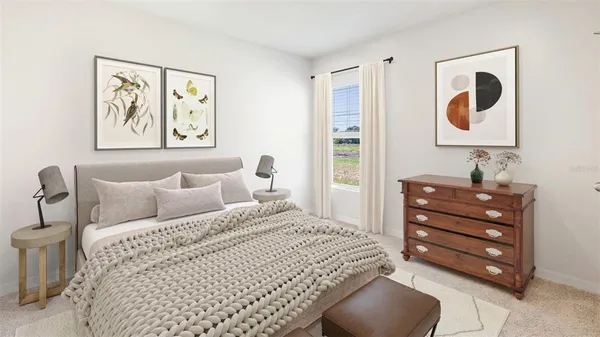 a bedroom with a bed and painting on the wall